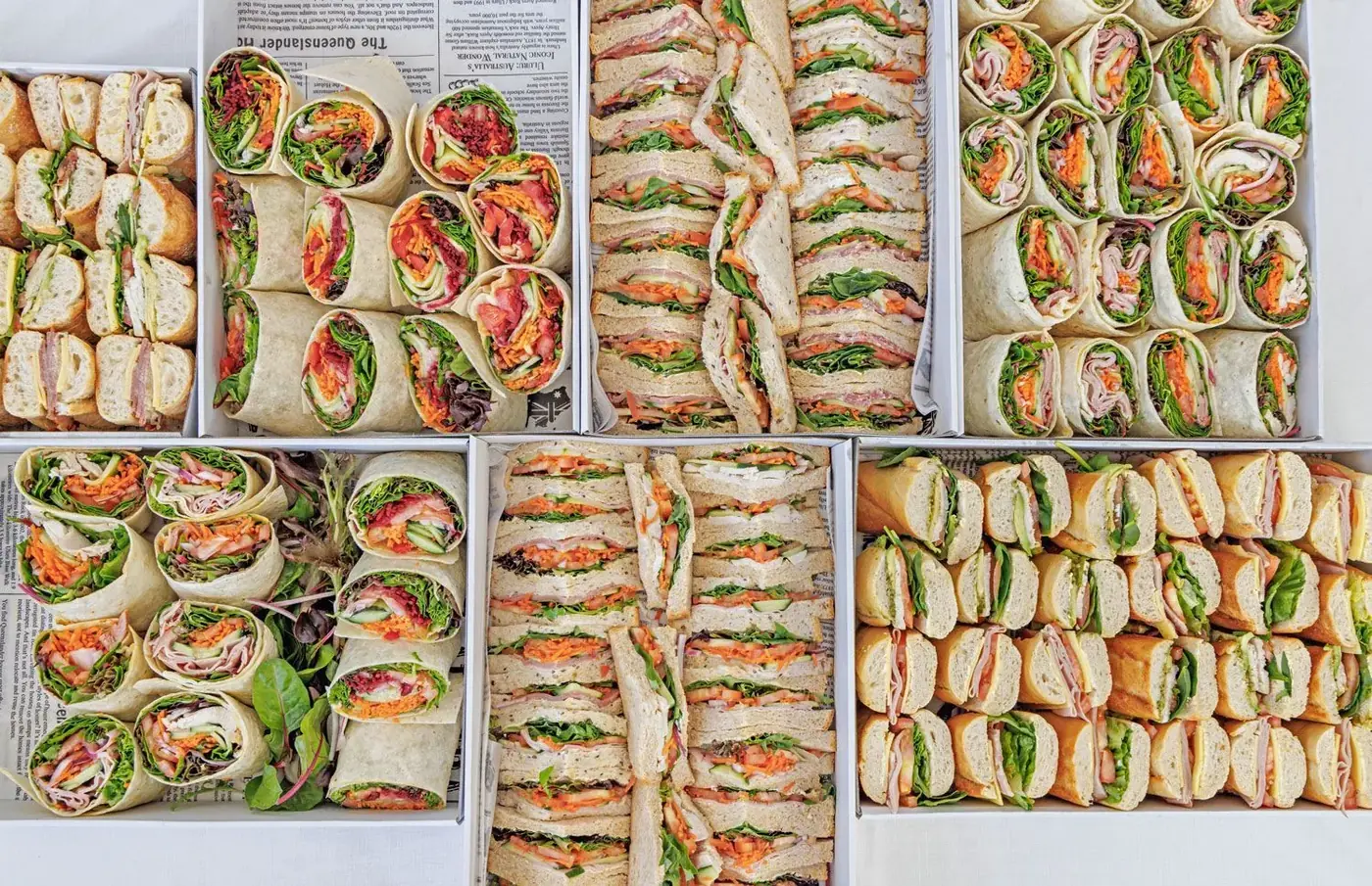 Platters of freshly made sandwiches, wraps and rolls in FNQ Foundation Feast catering boxes