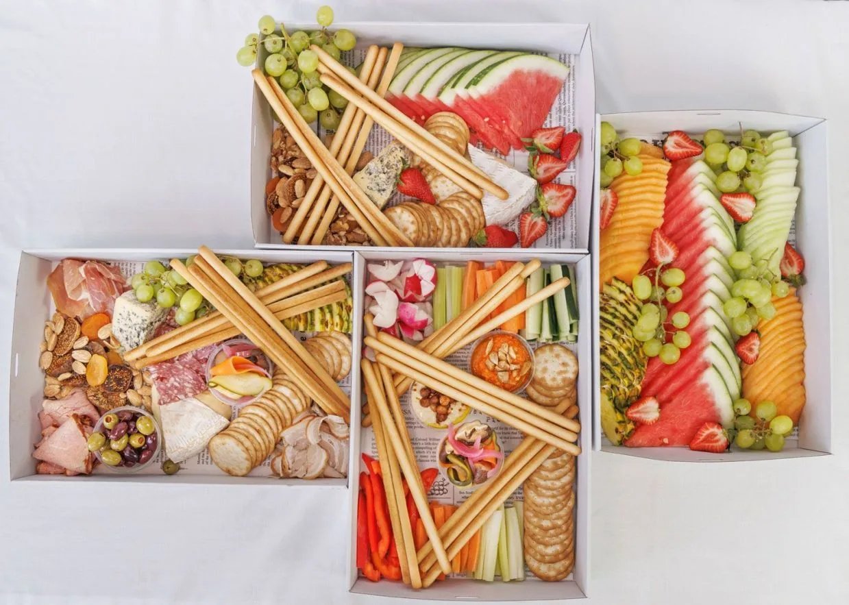 Grazing sharing box with fresh fruit, cheese, cured meats and crackers